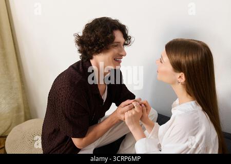 Joyful moments shared between a young couple in their stylish apartment, filled with warmth. Stock Photo