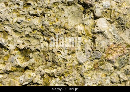 Weathered Stone Wall Texture Showing Cracks and Natural Patterns Stock Photo
