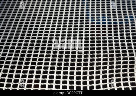 White mesh on black. Cellular grid of white color on a black background. Stock Photo