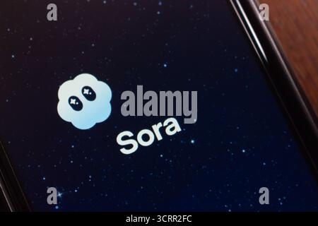 Smartphone displaying Sora app launch screen with a starry night background and its cloud logo, highlighting the next-gen AI video social network. Stock Photo