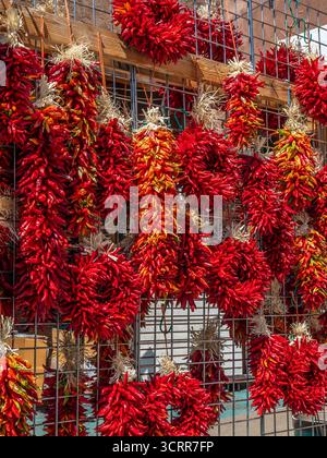 Chili peppers at a sidewalk vendor, downtown Santa Fe, New Mexico. Stock Photo