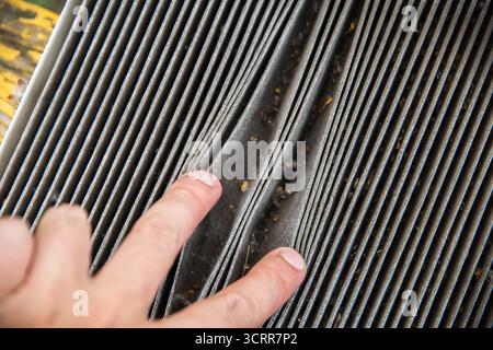Old dirty carbon cabin filter of the car. Concept of replacement with a new one. Cleaning the air in the car cabin Stock Photo
