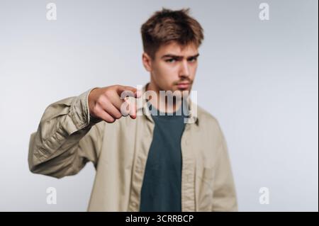 Young man pointing at the camera with a serious expression. Stock Photo