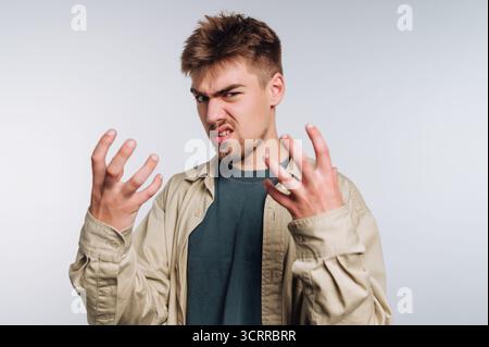 Young man expressing frustration with hands raised Stock Photo