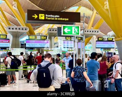 Madrid international airport, terminal 4S, passengers queue to check in for their flight with Qatar Airways,Spain,Europe Stock Photo