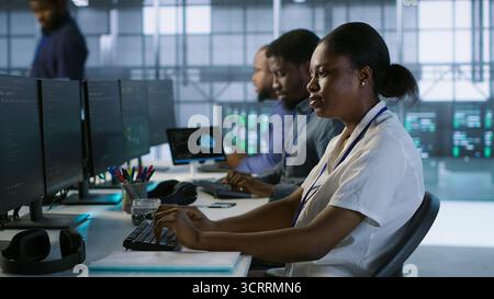Admin arriving in server room, starting work on developing disaster recovery plans ensuring minimal downtime. Employee entering data center, beginning job shift, monitoring performance, camera A Stock Photo