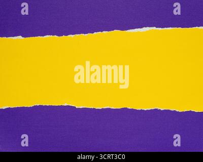 A yellow piece of paper torn on a purple background Stock Photo