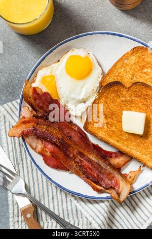 Healthy American Bacon Egg and Toast Breakfast with Orange Juice Stock Photo