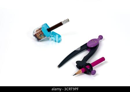 School or office supplies for geometry, drafting, and design, including a compass and a sharpener. A concept for education, precision, mathematics, an Stock Photo