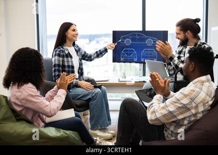Group of professionals discussing car design in a modern office Stock Photo