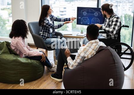 Team brainstorming car design ideas using modern technology Stock Photo