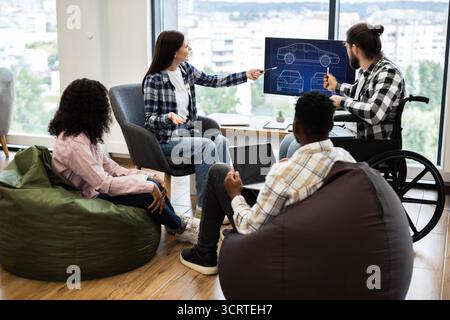 Team brainstorming car design ideas using modern technology Stock Photo