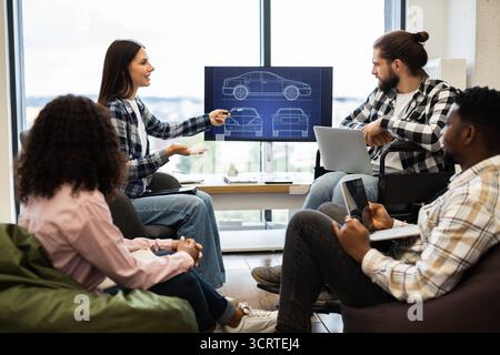 Team discussing car design project with informatic display for collaboration Stock Photo