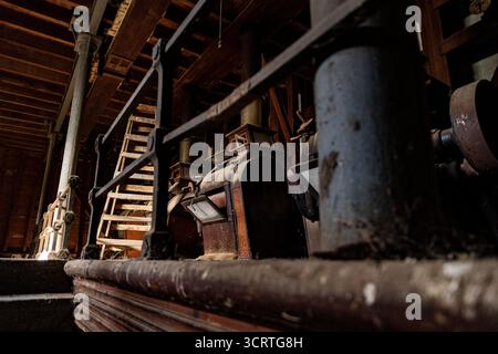 Rustic industrial equipment fills the interior of a historical workshop showcasing its unique craftsmanship. Stock Photo