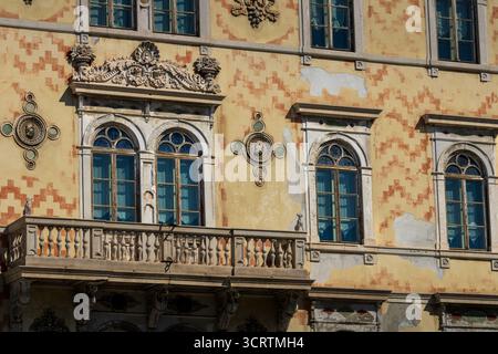 ornate yellow facade with arched windows Stock Photo