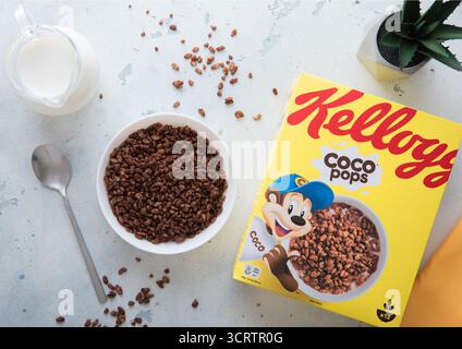LONDON,UK - MAY 28, 2025: Kellogg's coco pops breakfast cereal in bowl plate with spoon and milk jar on kitchen table. Stock Photo