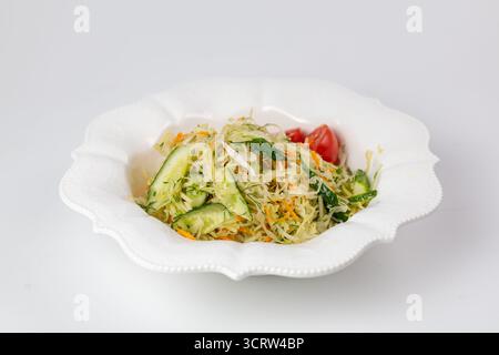 Side view of salad with cabbage, carrots, and cucumbers. Highlights freshness and volume. perfect for product ads and packaging. Stock Photo