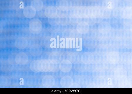 Abstract circular bokeh background, defocused dots on blue background Stock Photo
