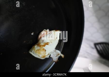 Fried Egg in Black Skillet Over Countertop Stock Photo
