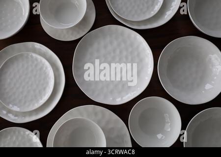White Textured Dinnerware Set on Table Stock Photo