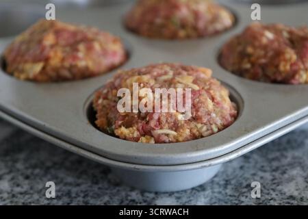 Close-up of raw meatloaf muffins in pan Stock Photo