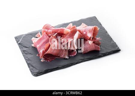 Slices of Spanish Serrano Ham isolated on White Background. Typical Mediterranean cured meat, gourmet food often served as tapas, appetizer or in char Stock Photo