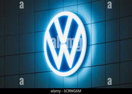 Volkswagen automotive brand logo on the wall outside the dealership in Dusseldorf, Germany Stock Photo