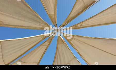 The shade sail which is a type of outdoor covering used to provide shade and protection from the sun. Stock Photo