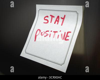 A positive message on a sticky note, Hangeing on the fridge. Stock Photo