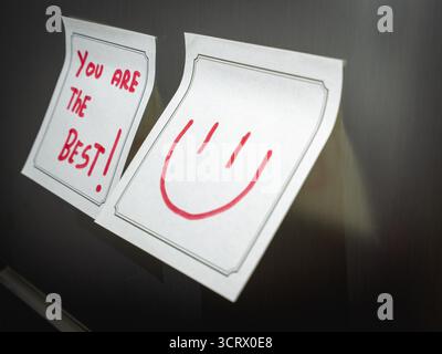 A positive message on a sticky note, Hangeing on the fridge. Stock Photo