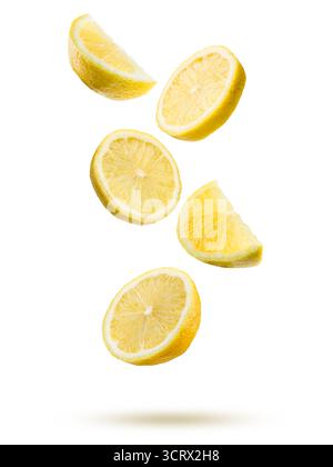 Lemon fruit slices falling on white background. Stock Photo
