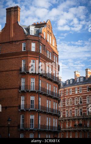 View of Albert Hall Mansions, the red-brick residential building behind the Royal Albert Hall in London, captured in the late afternoon sunlight with Stock Photo