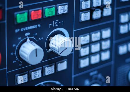 Control panel of old CNC milling machine. Detailed close-up of an industrial control panel featuring various buttons and displays. Selective focus. Stock Photo