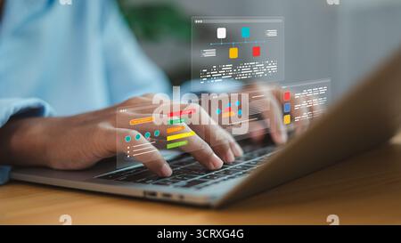 Close up of hands typing on laptop with holographic data charts, workflow diagram, and digital interface, concept of business data analytics, project Stock Photo