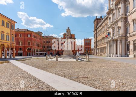 Modena Italy Piazza Roma with statue and historic buildings on a sunny day Stock Photo