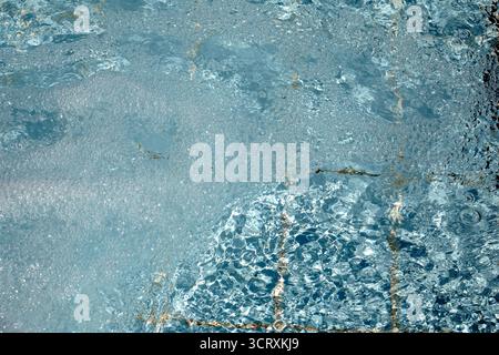 Agitated water ripples in a swimming pool Stock Photo