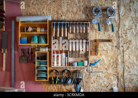 Woodworker workstation with organized tools on wall inside workshop cabinet. DIY instruments Stock Photo