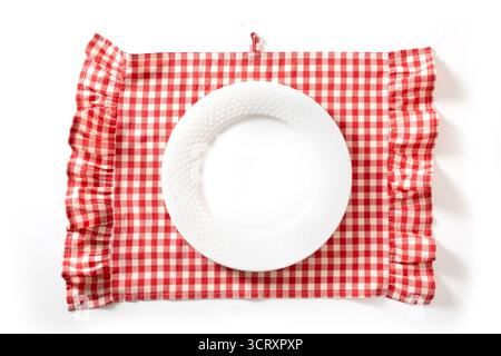 Empty white plate and cooking red checkered kitchen towel isolated on white background. Space for design. Top view. Stock Photo