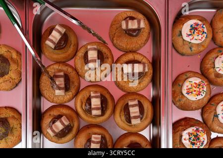 Cookies with Kinder Bueno & sprinkles are prepared in a bakery in London, UK. Stock Photo