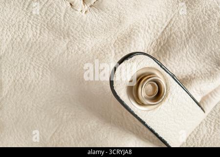 Light beige leather bag details closeup as a background Stock Photo