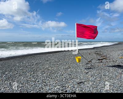 Red flag warning on beach during high wind and surf weather conditions Stock Photo