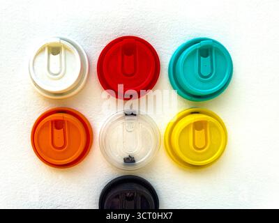 Collection of colorful plastic cup lids arranged in a grid pattern on a white background ipoh, malaysia Stock Photo