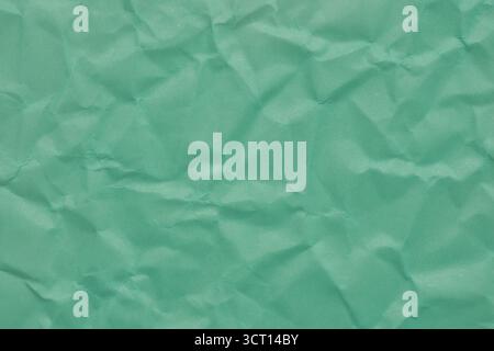 This turquoise paper showcases a lively texture with crumples and folds, perfect for background designs, crafts, or artistic creations in various proj Stock Photo