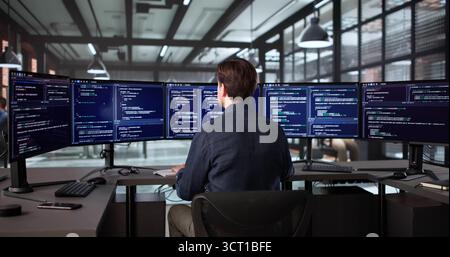 Elderly Man In Office Developing Software On Desktop Computer Screen Stock Photo