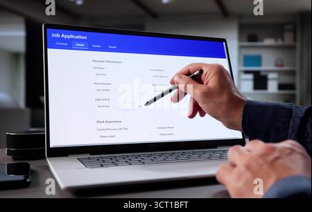 Senior Man Applying For Corporate Job Online Using Laptop Computer. Stock Photo