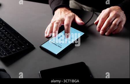 Senior Man Stealing Data From Smartphone Using Hacking Software Anonymously. Stock Photo