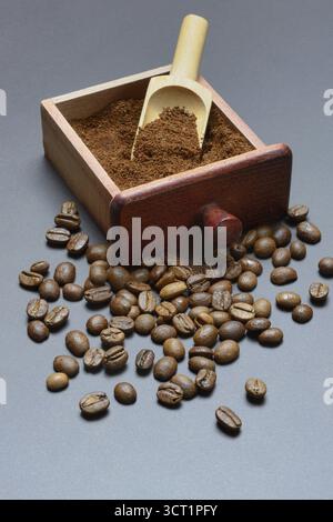 Coffee, ground coffee in the drawer of a coffee grinder and coffee beans Stock Photo
