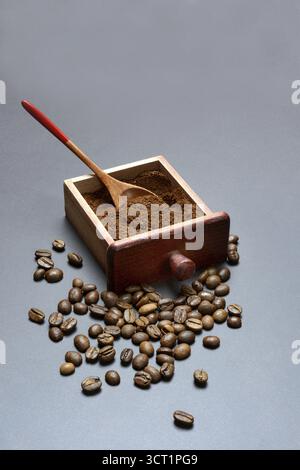 Coffee, ground coffee in the drawer of a coffee grinder and coffee beans Stock Photo