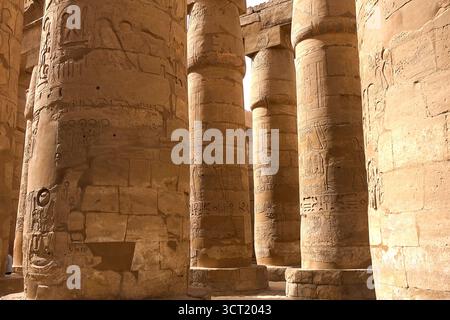Egyptian hieroglyphs and drawings on the walls and columns. Egyptian language, The life of ancient gods and people in hieroglyphics and drawings Stock Photo