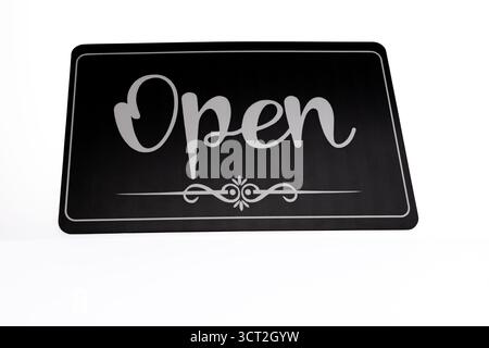 White lettering on black background: OPEN sign in window, welcoming customers  Stock Photo